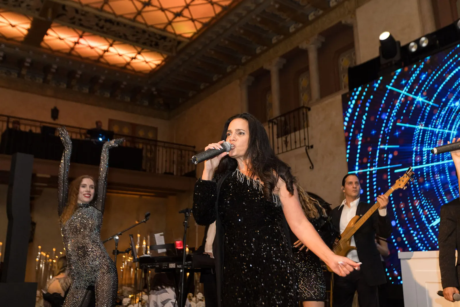 Live band performing with a singer on stage under colorful lighting at the Edge 2025 gala, photographed by Marquee Visuals.