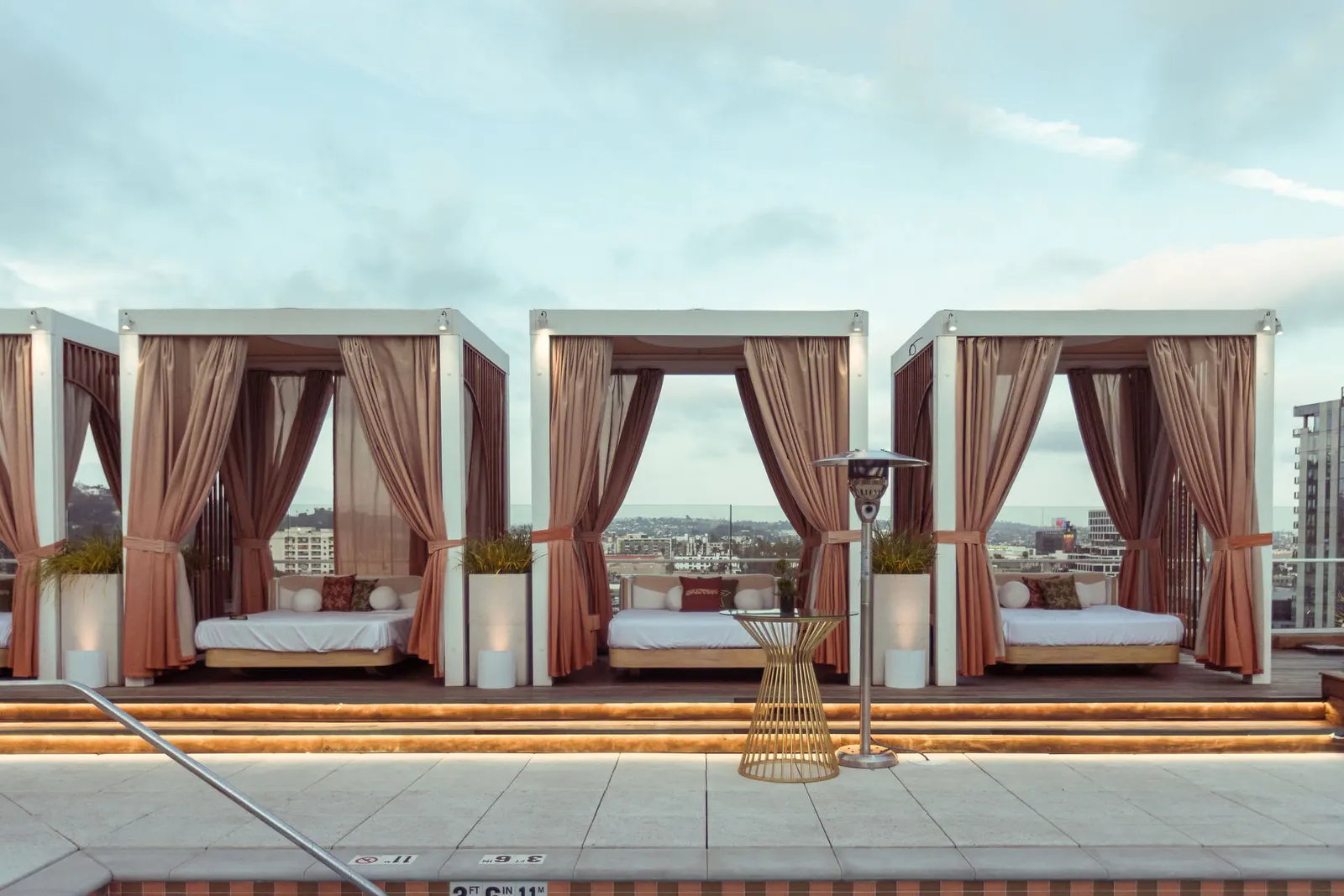 Rooftop cabanas with pink curtains at the Edge 2025 event venue, photographed by Marquee Visuals in Los Angeles.