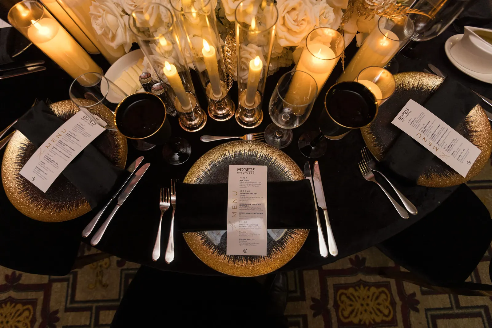 Close-up of a gala table setting with gold place settings and candlelight at the Edge 2025 event, photographed by Marquee Visuals.