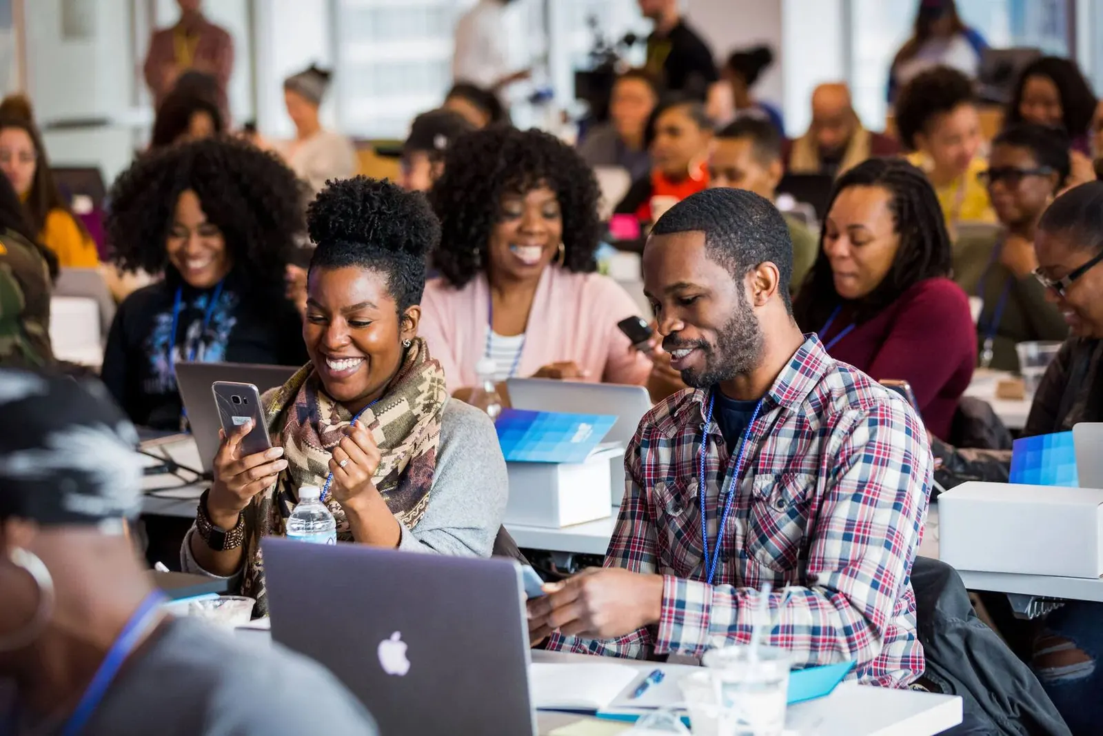 Candid shot of attendees seated at tables with laptops at the Level Up Chicago event, photographed by Marquee Visuals.