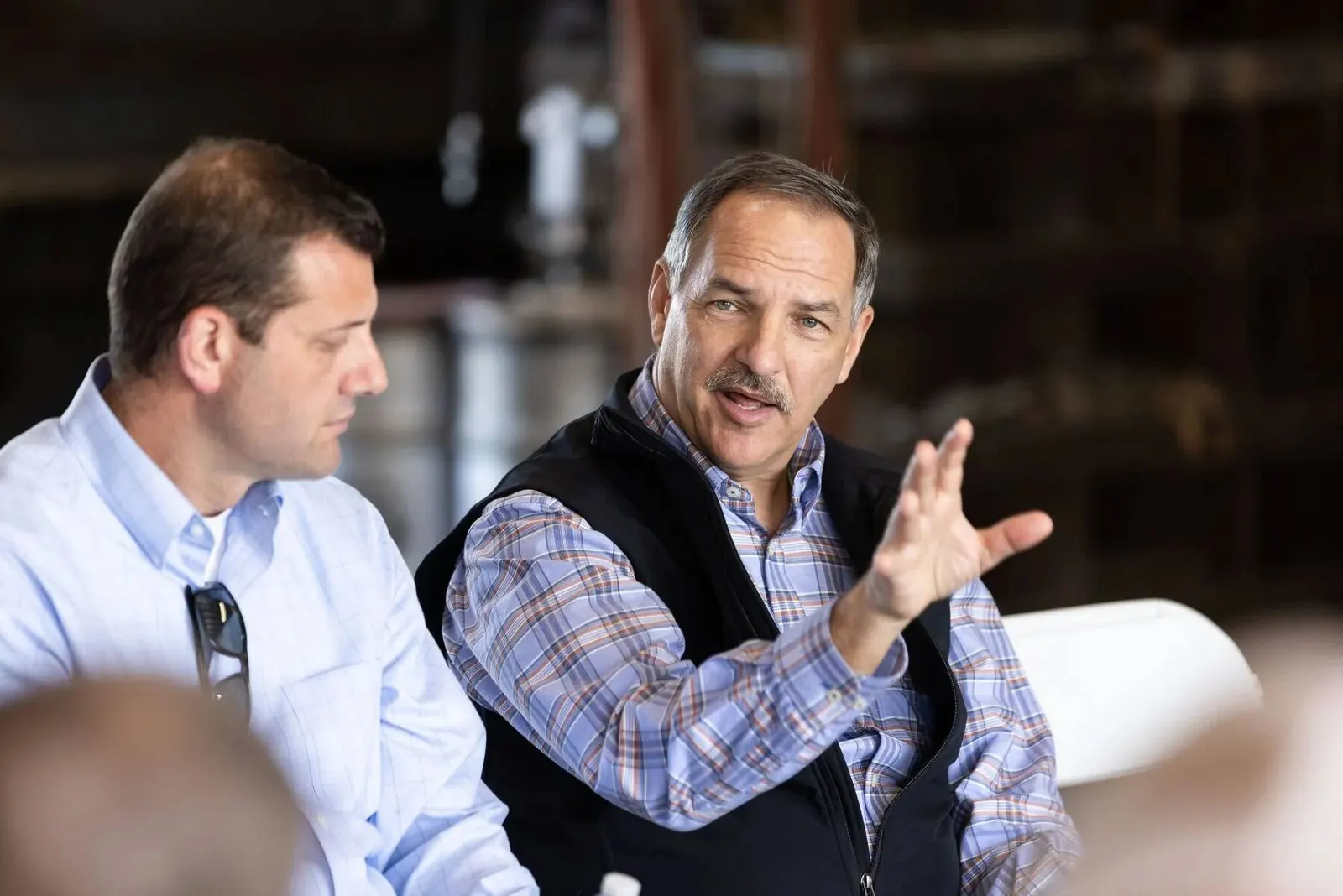 Two executives in candid conversation at the LOL Hanford event, photographed by Marquee Visuals.