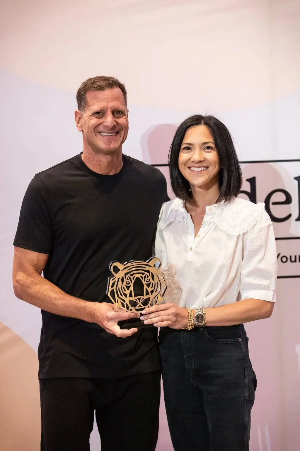 Man and woman posing together after receiving an award at the Nadel University awards ceremony, photographed by Marquee Visuals.