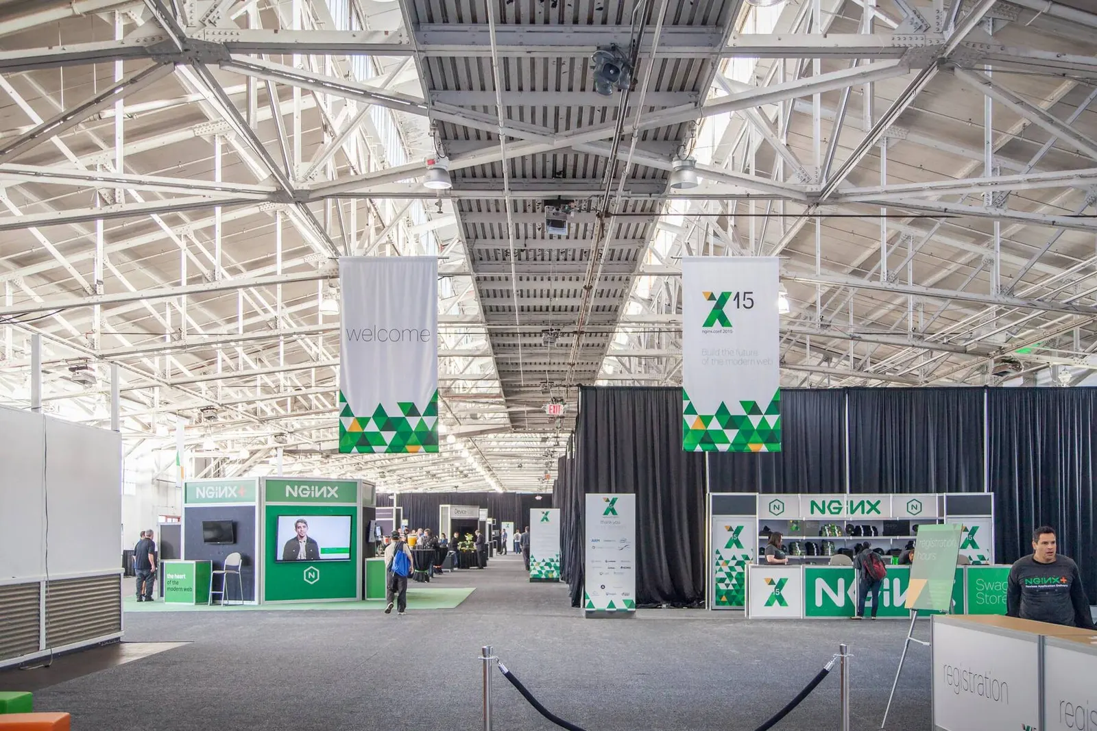 Wide view of a conference expo hall with exhibit booths at an NGINX conference, photographed by Marquee Visuals in the Bay Area.