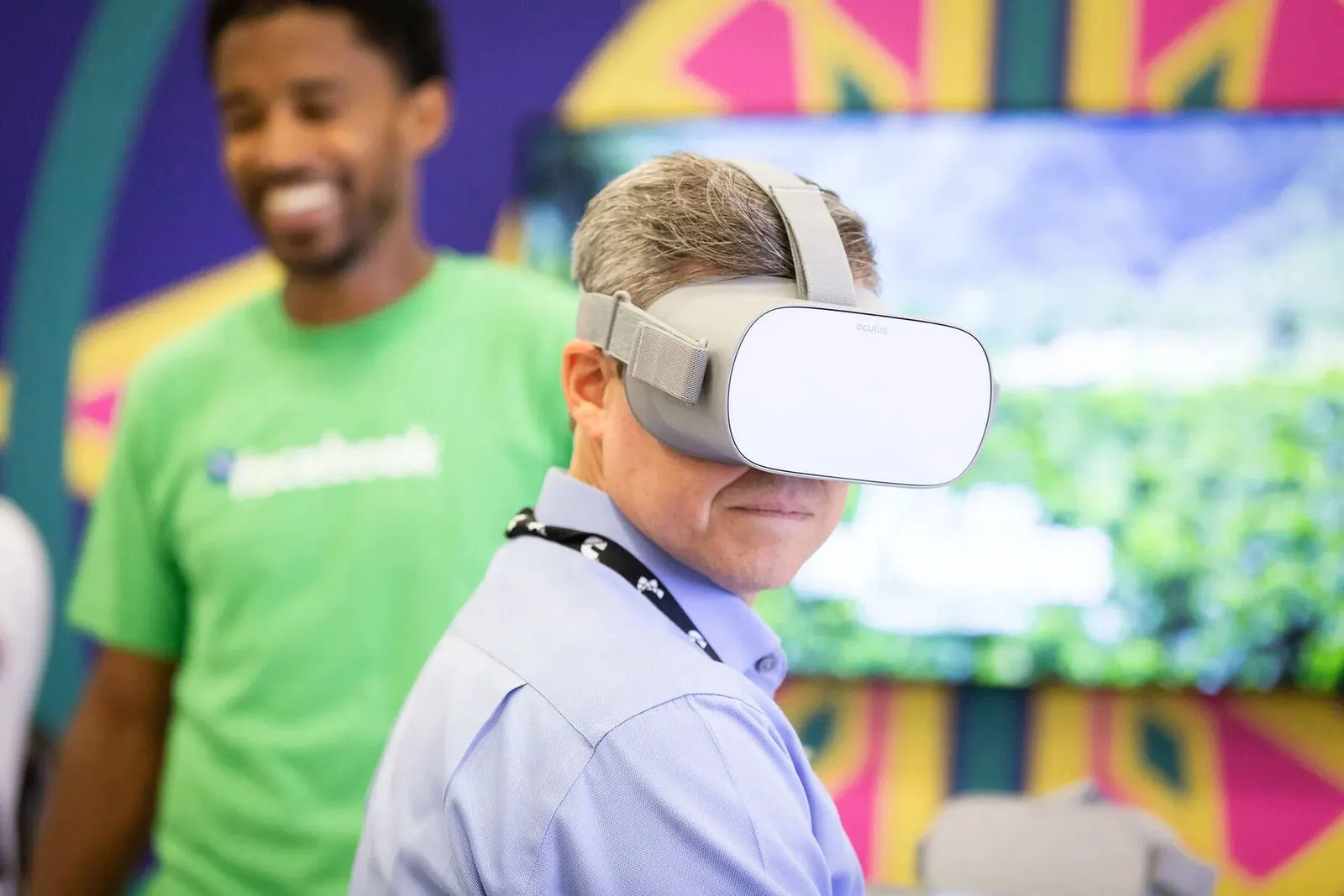 Attendee wearing a VR headset demo in a green Facebook shirt at the NMSDC Level Up event, photographed by Marquee Visuals.