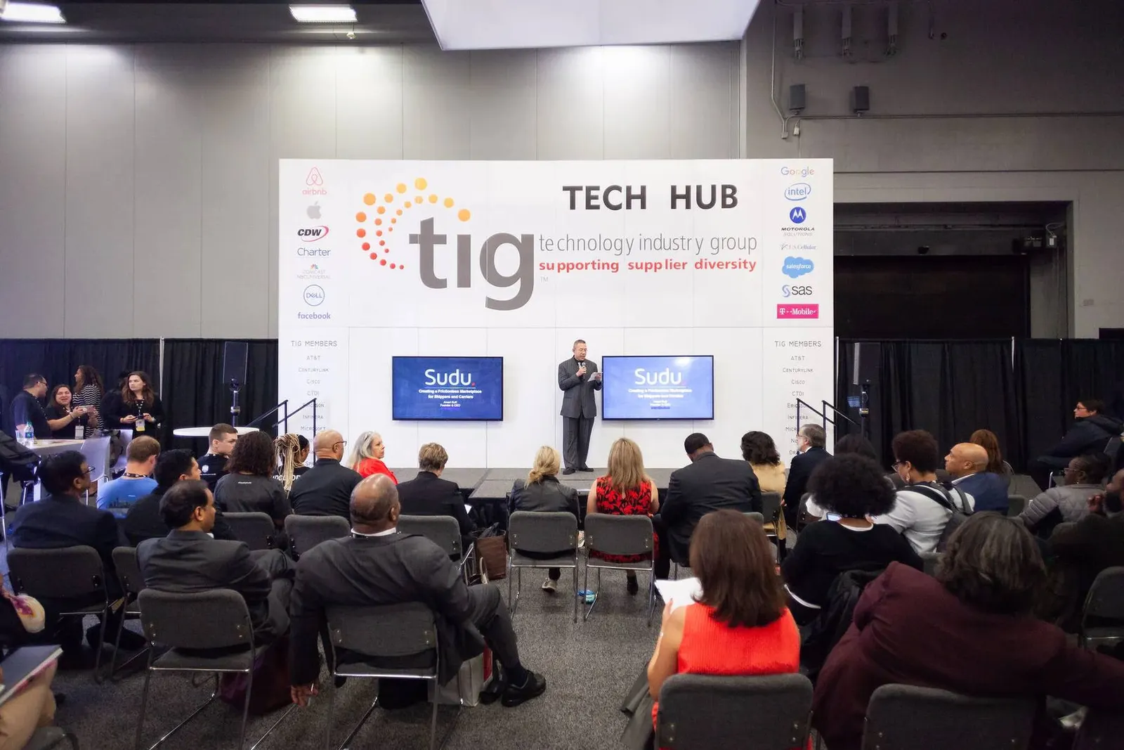 Wide view of a conference session at the Tech Hub stage with a seated audience at the NMSDC Level Up event, photographed by Marquee Visuals.