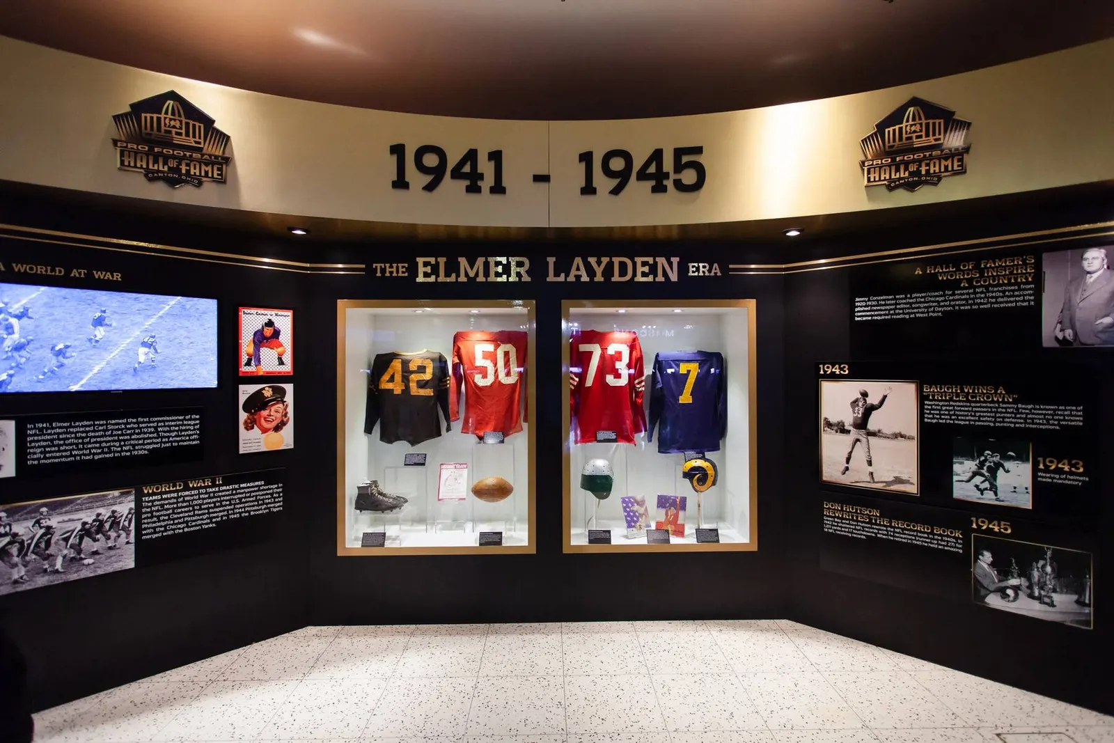 Museum exhibit wall displaying vintage football memorabilia and framed jerseys from 1941-1945, photographed by Marquee Visuals in the Bay Area.