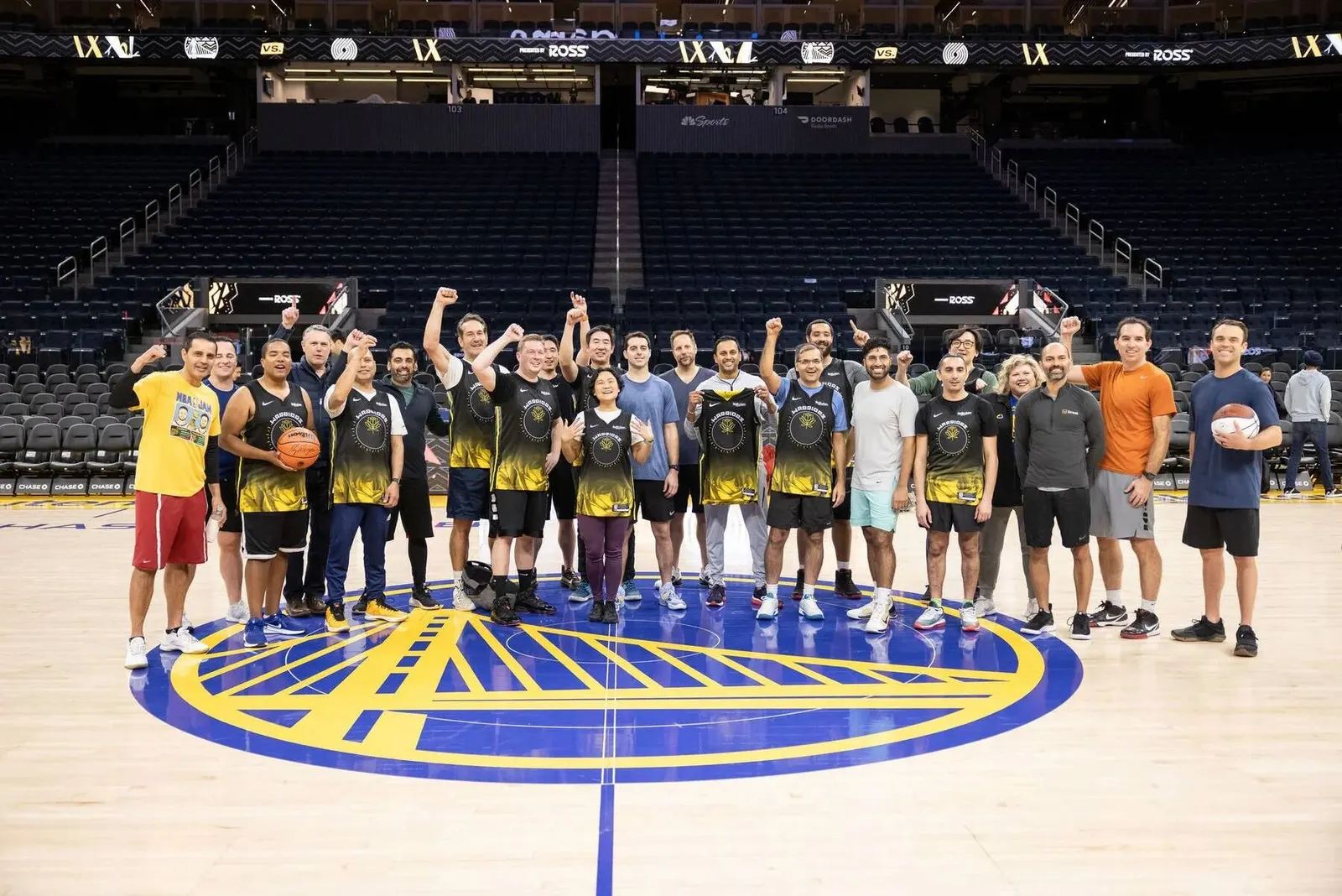 Group photo of participants standing on the Golden State Warriors home court, photographed by Marquee Visuals in the Bay Area.